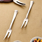 Close-up view of stainless steel fruit fork picking a piece of fruit