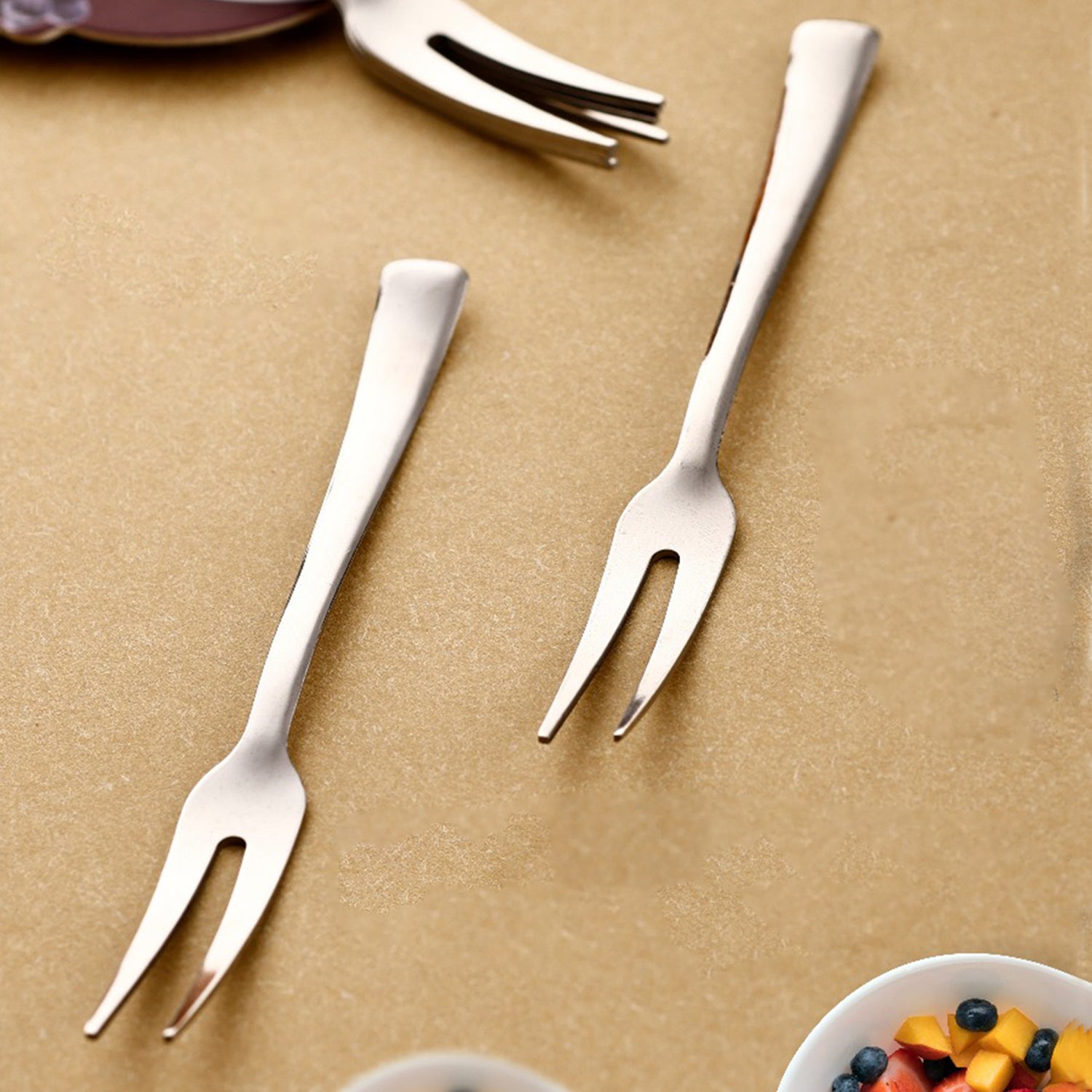 Close-up view of stainless steel fruit fork picking a piece of fruit