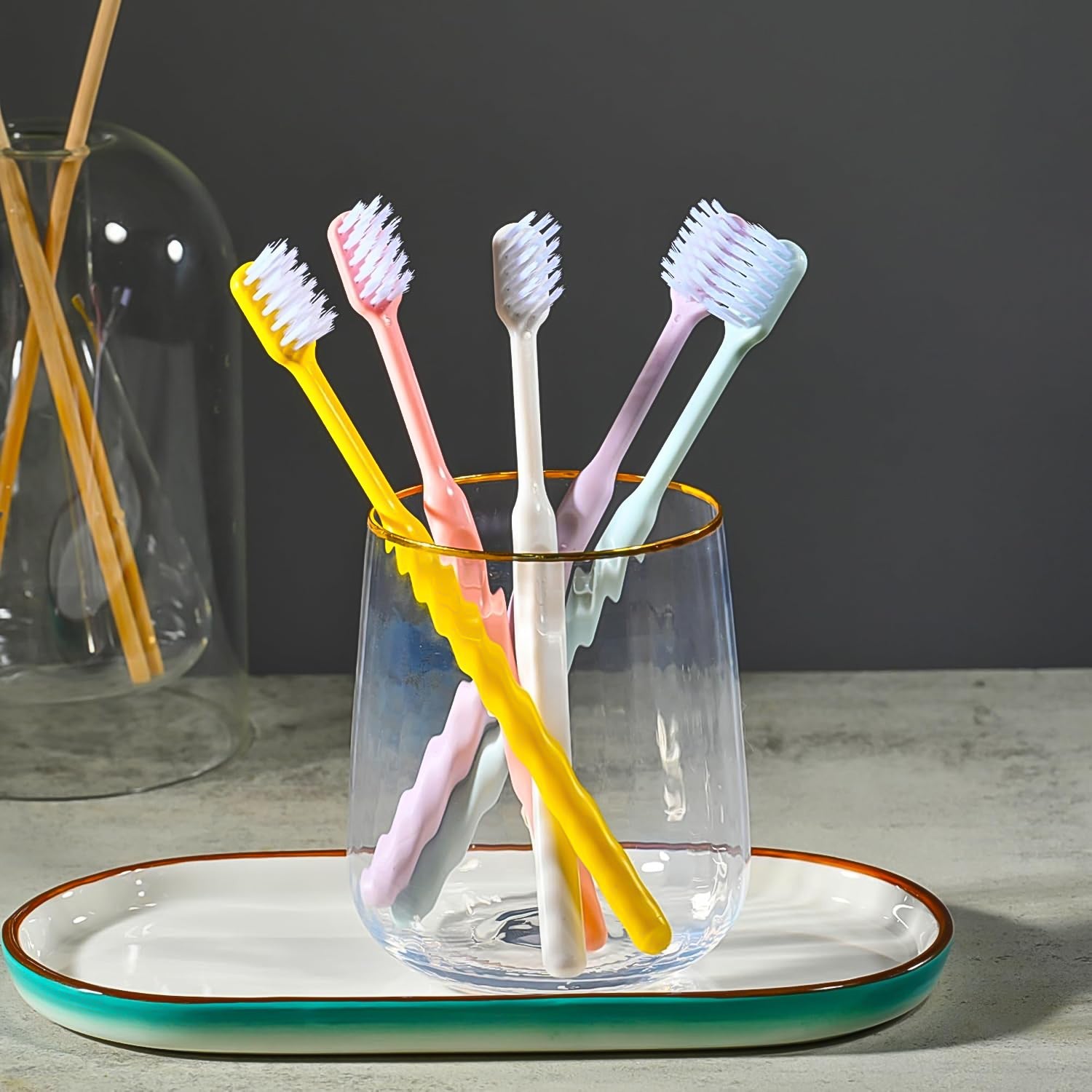 Soft plastic toothbrush set with vibrant colors and a portable round box, perfect for family oral hygiene.