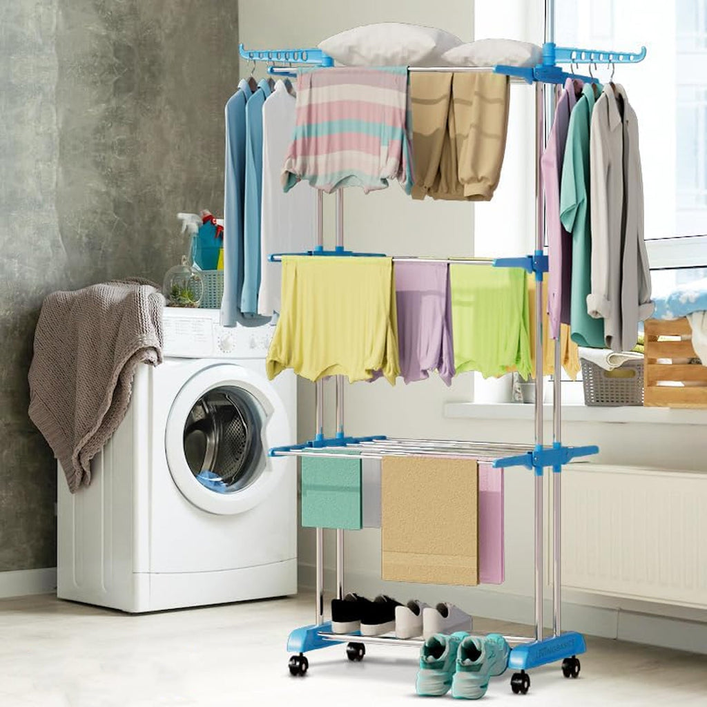 An individual tier of the clothes stand holding various garments for drying.