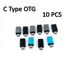 Hand holding a compact Micro USB OTG adapter, highlighting its portable design.