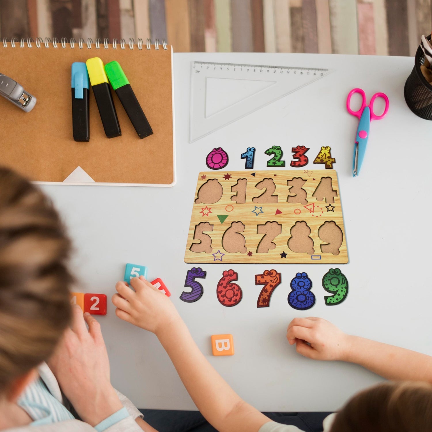 Individual colorful wooden number puzzle pieces scattered next to the board.