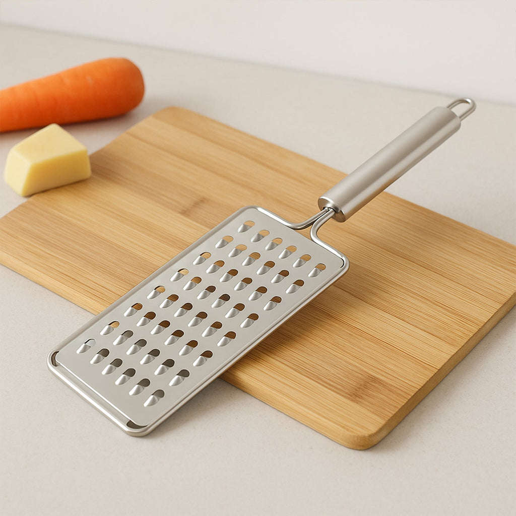Flat stainless steel grater showing sharp blades and sturdy handle