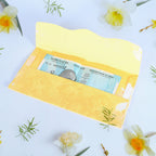 A neat stack of multicoloured premium cash gift envelopes with elegant purse handles.