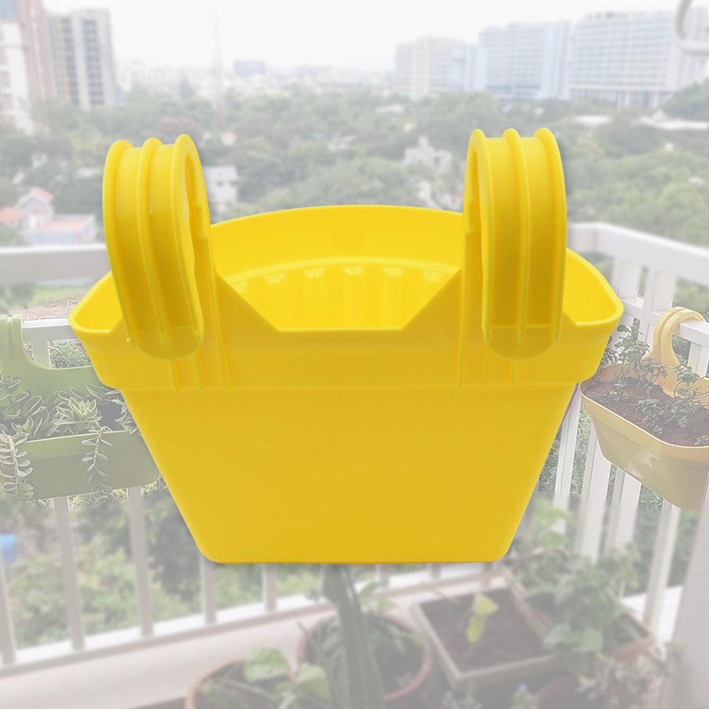 Hanging plastic planter displayed to show its suitable size for various plants.