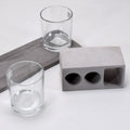 Elegant wine glass holder set with two glasses on a marble base, ideal for home decor.