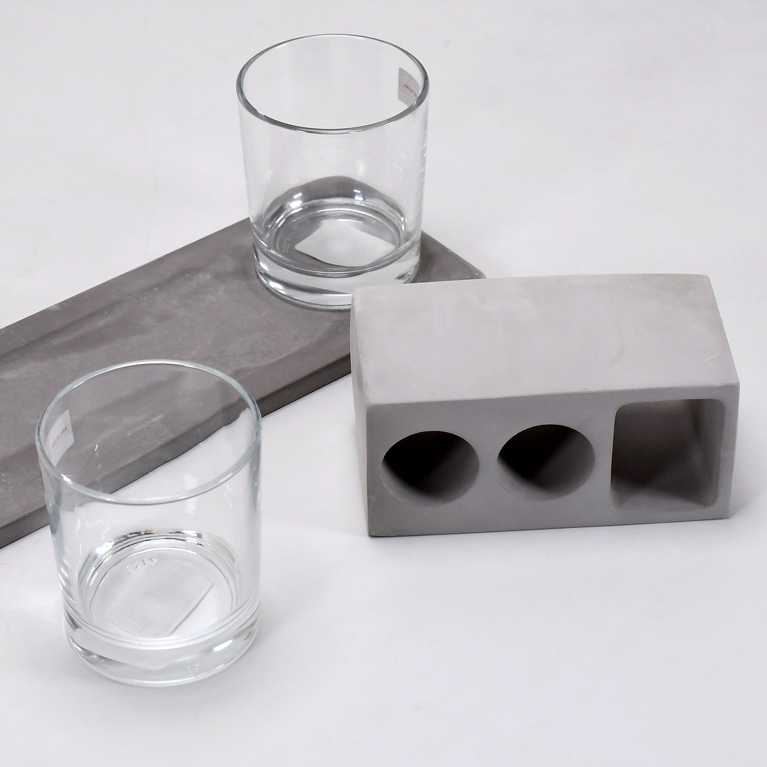 Elegant wine glass holder set with two glasses on a marble base, ideal for home decor.