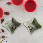 Close-up of a durable ceramic tea cup and plastic snack bowl from the 4-piece set.