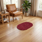 Red oval floor mat in a room setting for entryway decor