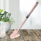 Triangular cleaning brush with long handle, ready for kitchen use.