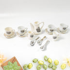 Miniature plastic cups, saucers, and spoons arranged for a pretend tea party.