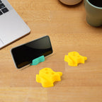 Apple-shaped plastic mobile stand with built-in pen holder on desk