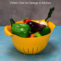A plastic rice washing bowl in blue, perfect for draining fruits and vegetables.