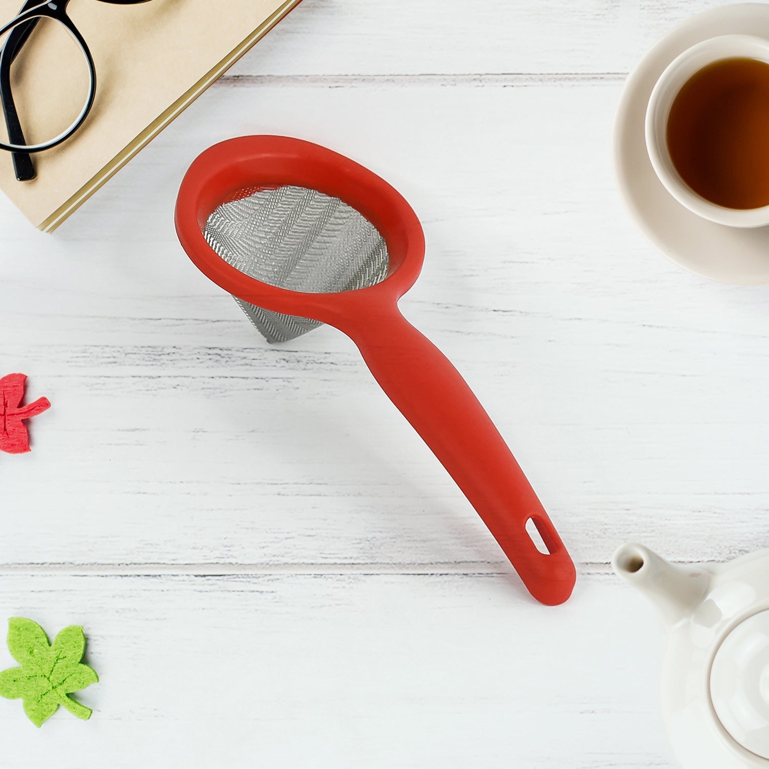 Green tea strainer featuring fine mesh and red plastic handle