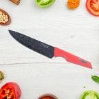Red handle kitchen knives with marble-finish blades resting on counter