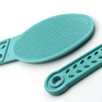 Side profile of the plastic foot scrubber, showcasing its slim design for easy storage.