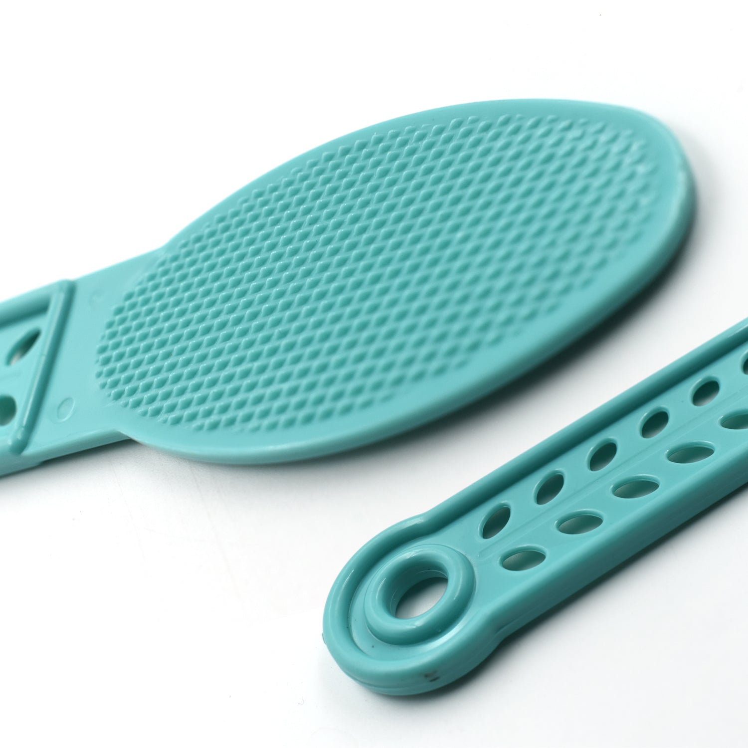 Side profile of the plastic foot scrubber, showcasing its slim design for easy storage.