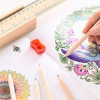 Top-down view of twelve colorful wooden pencils laid out in a fan shape.