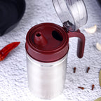 Stainless steel oil container with its small nozzle and lid, ready for use.
