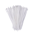 A hand holding flexible black self-locking cable ties, demonstrating their durability.