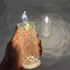 Close-up of a sparkling crystal LED rose candle glowing softly.