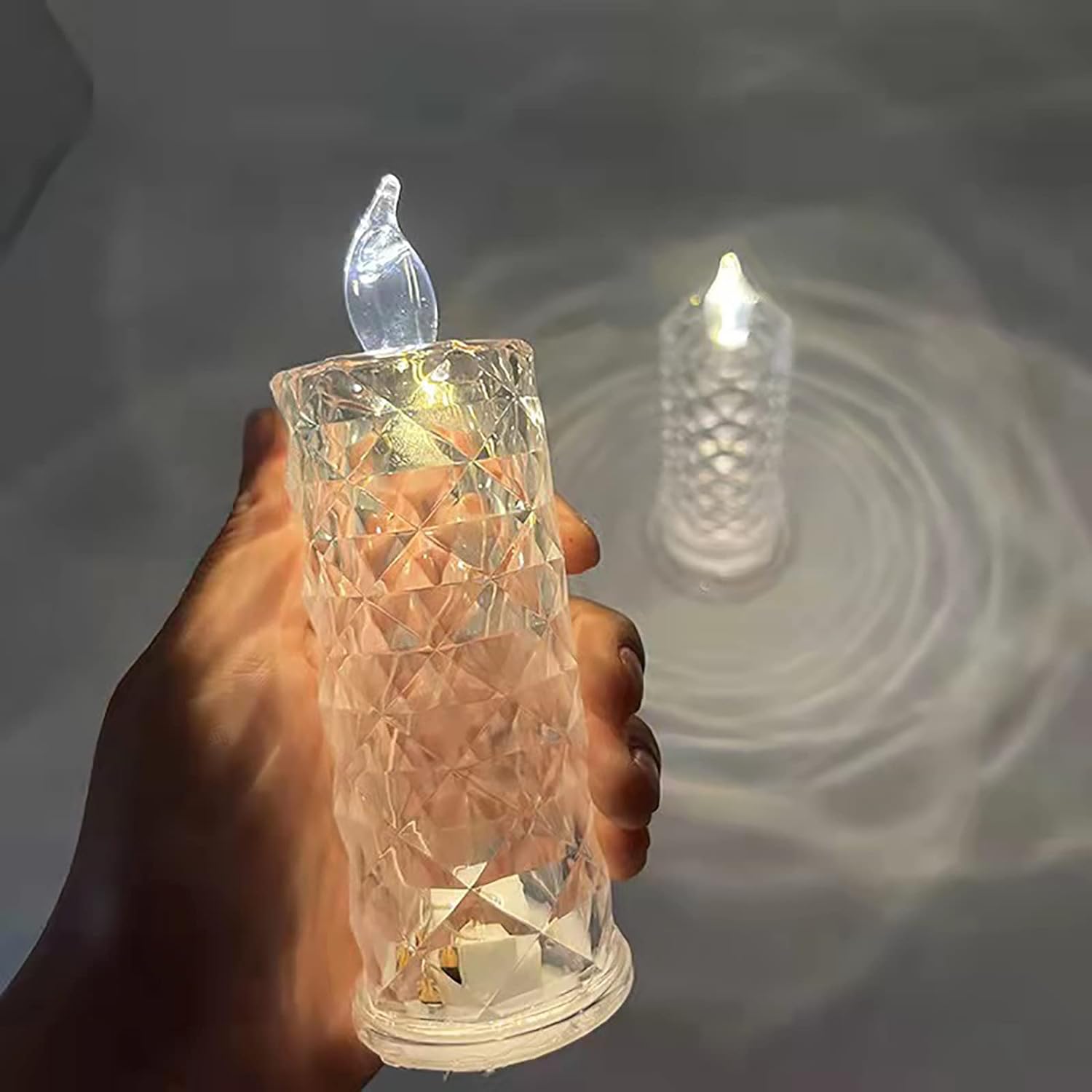 Close-up of a sparkling crystal LED rose candle glowing softly.
