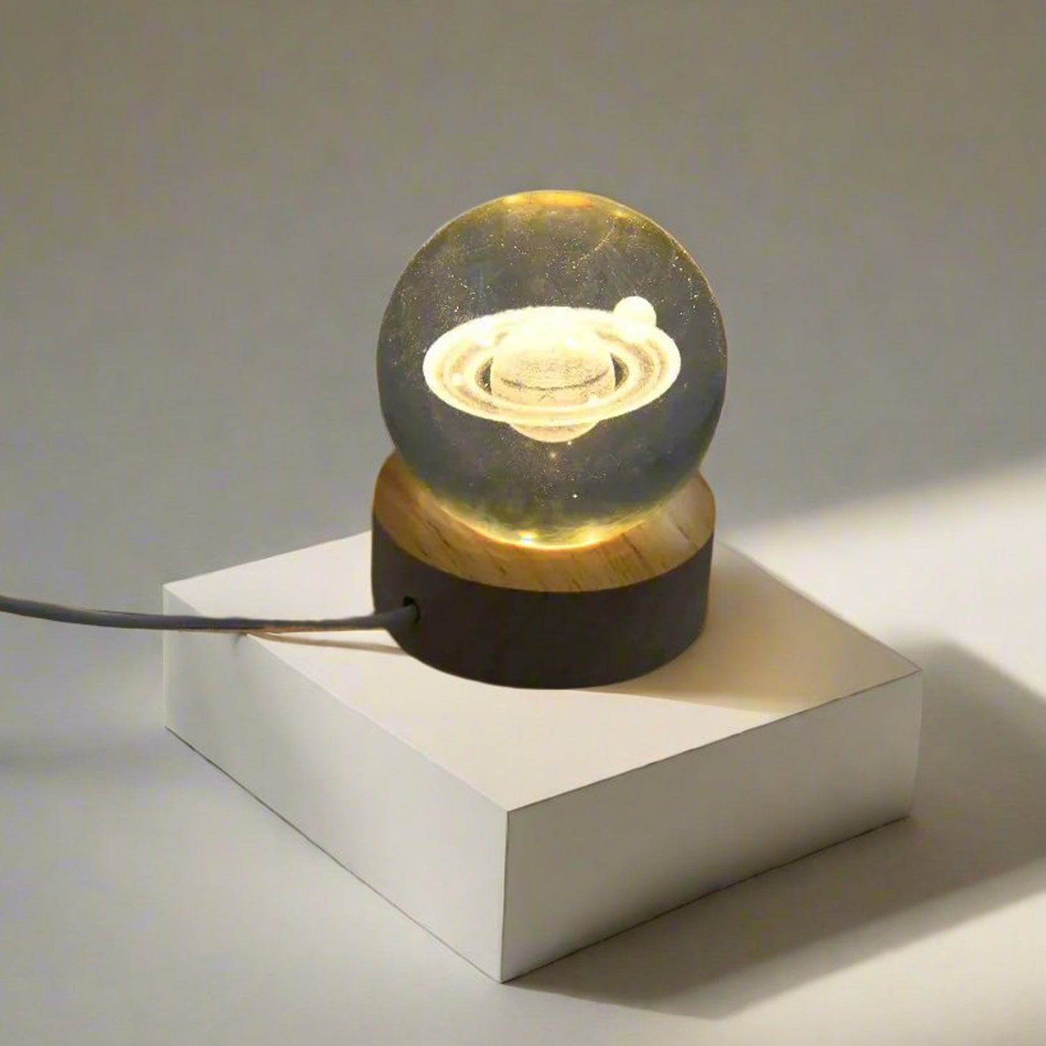 Astronaut Crystal Ball Night Light on a rustic wooden base.