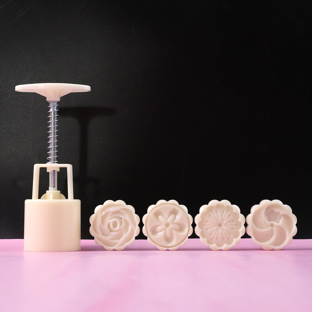 Angled view of 4-in-1 spring press cookie mold set for precise baking