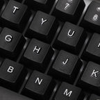 Angled view of the wired keyboard, highlighting its full-size layout and ergonomic key placement.