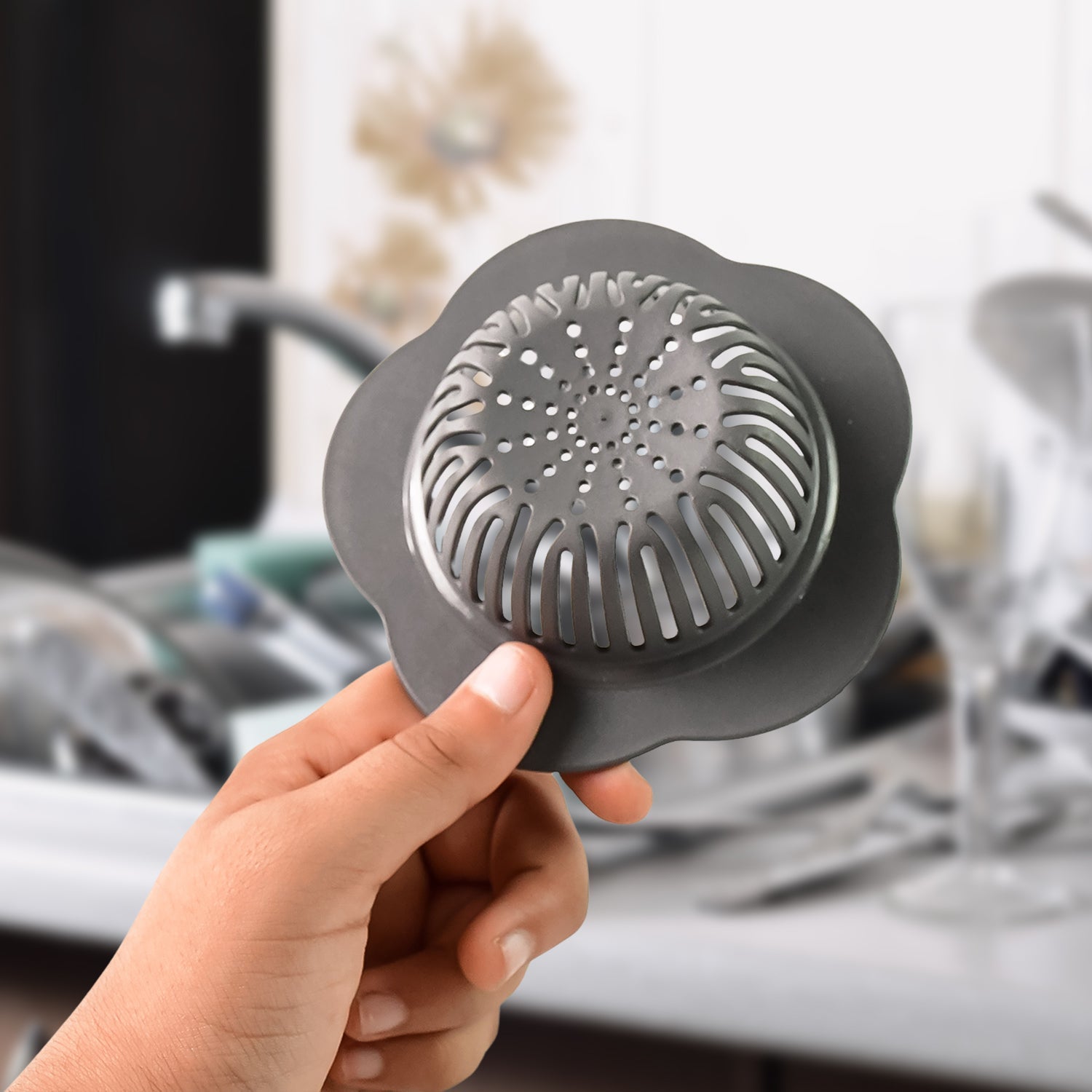 Underside view of plastic sink strainer showing perforated design