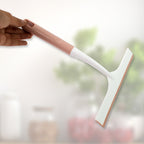 A hand demonstrating the small detailing brush for intricate cleaning tasks.
