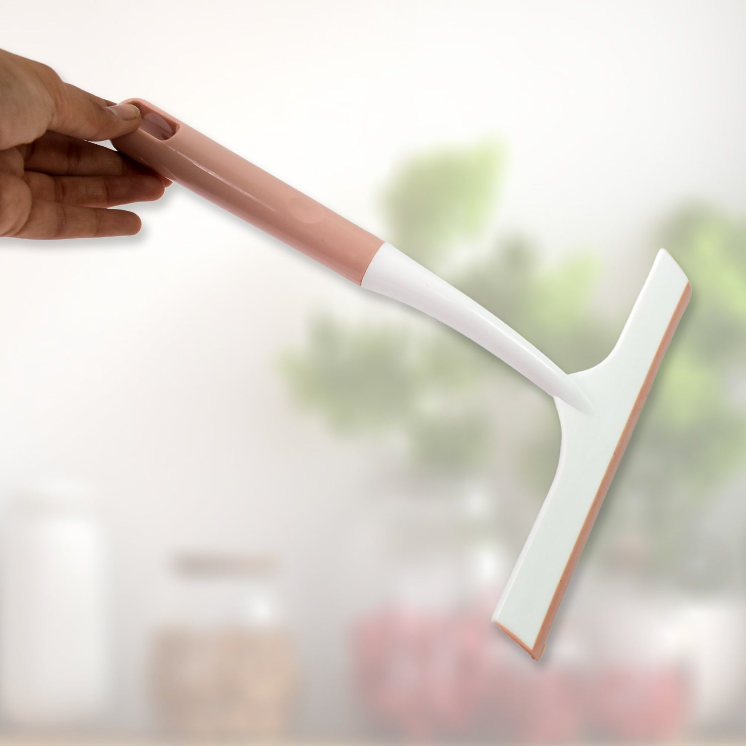 A hand demonstrating the small detailing brush for intricate cleaning tasks.