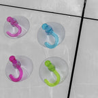 Pack of 12 transparent suction hooks ready for home use.