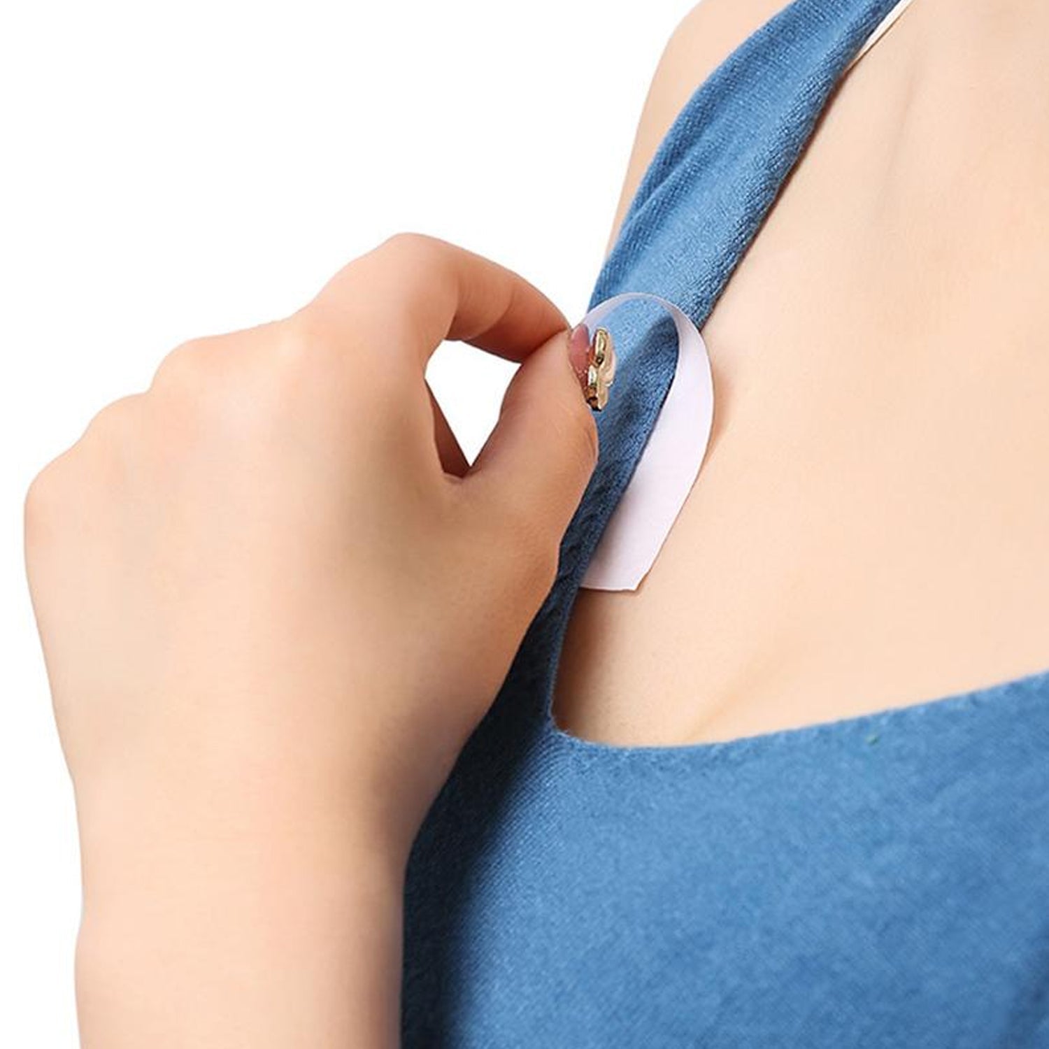 Clear double-sided tape applied to a delicate fabric, demonstrating its strong, discreet hold.