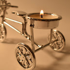 Close-up of tealight candle burning on decorative cycle stand holder