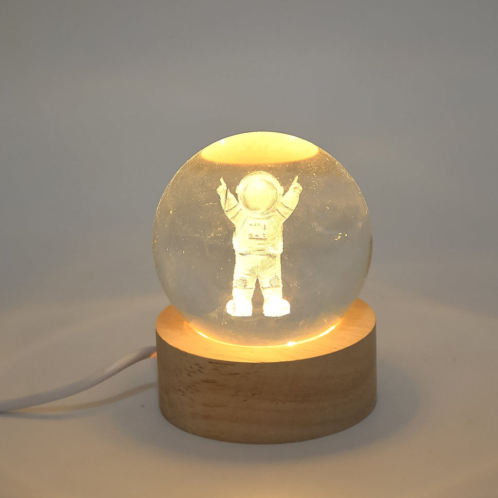 A Moon Crystal Ball Lamp displayed on a bedside table, creating a serene bedroom decor ambiance.