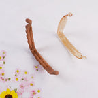 Plastic claw hair clip designed to hold hair firmly and stylishly