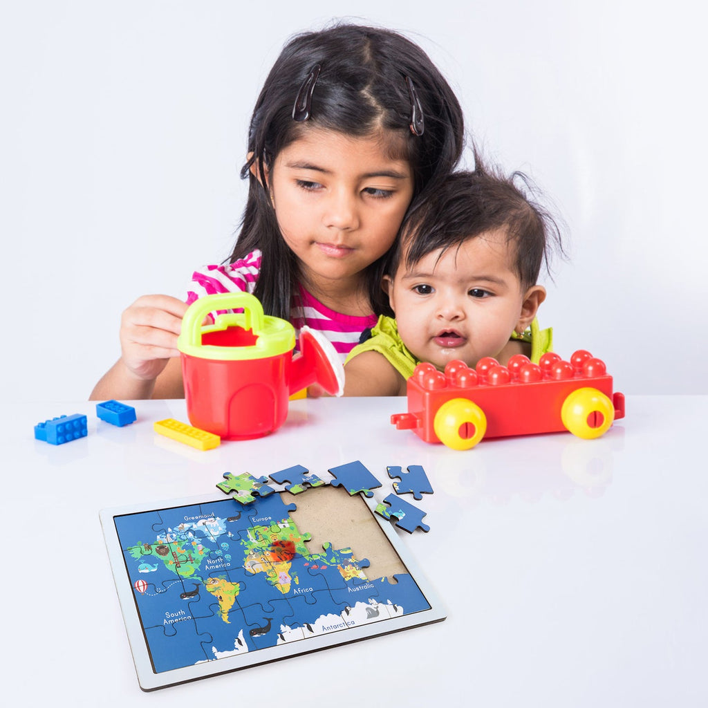 Individual wooden puzzle pieces showing different continents and their distinct shapes.