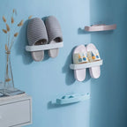 Organized bathroom with the self-adhesive towel and slipper rack in daily use, holding essentials.