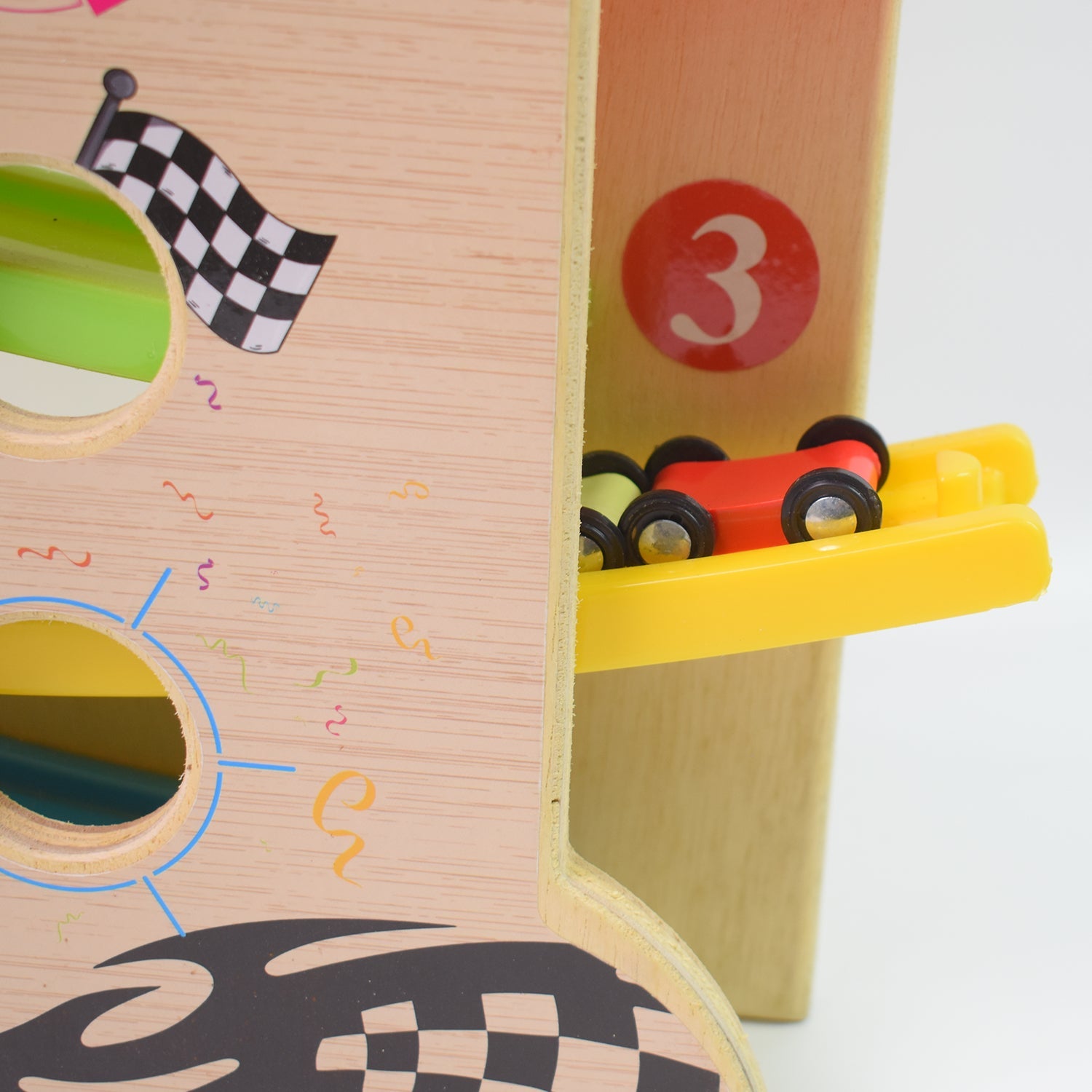 Top-down view of the wooden ramp racer track with cars ready for a race.