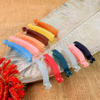 Set of 12 vibrant banana hair clips made from durable plastic