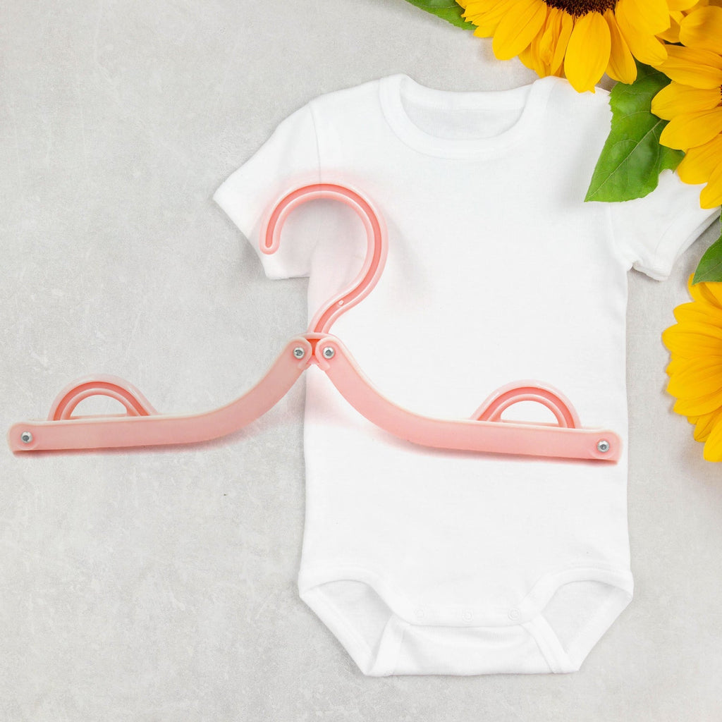 Compact travel hangers in various colours, ideal for drying and organising clothes on the go.