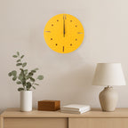 Side view of yellow round wall clock showing slim profile