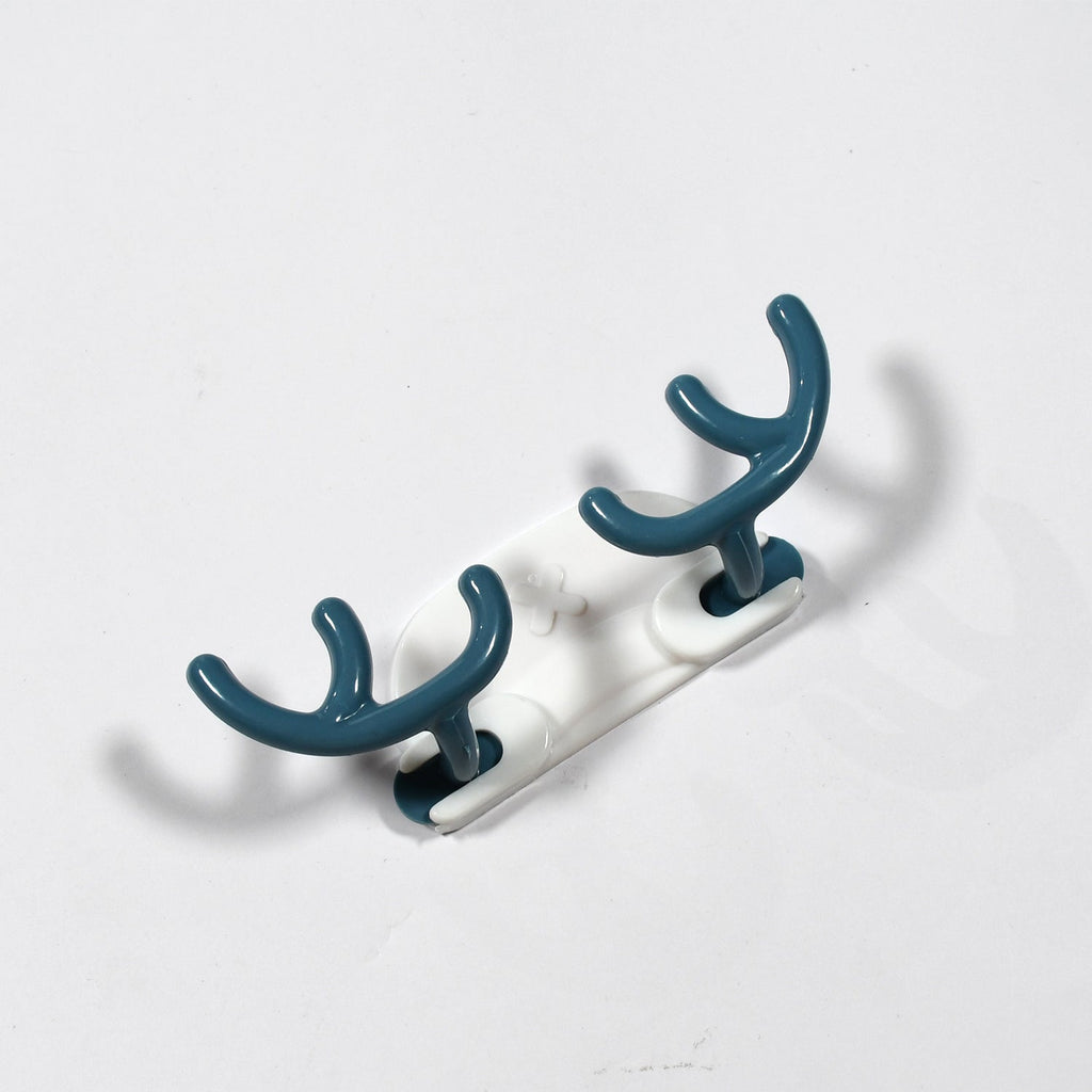 Side view of a white plastic wall hook securely attached to a wall.