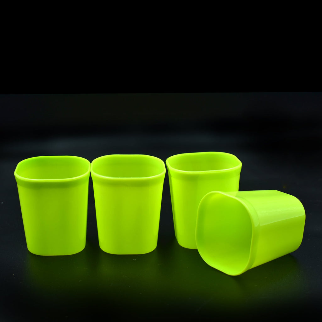 Set of four clear unbreakable plastic drinking glasses.