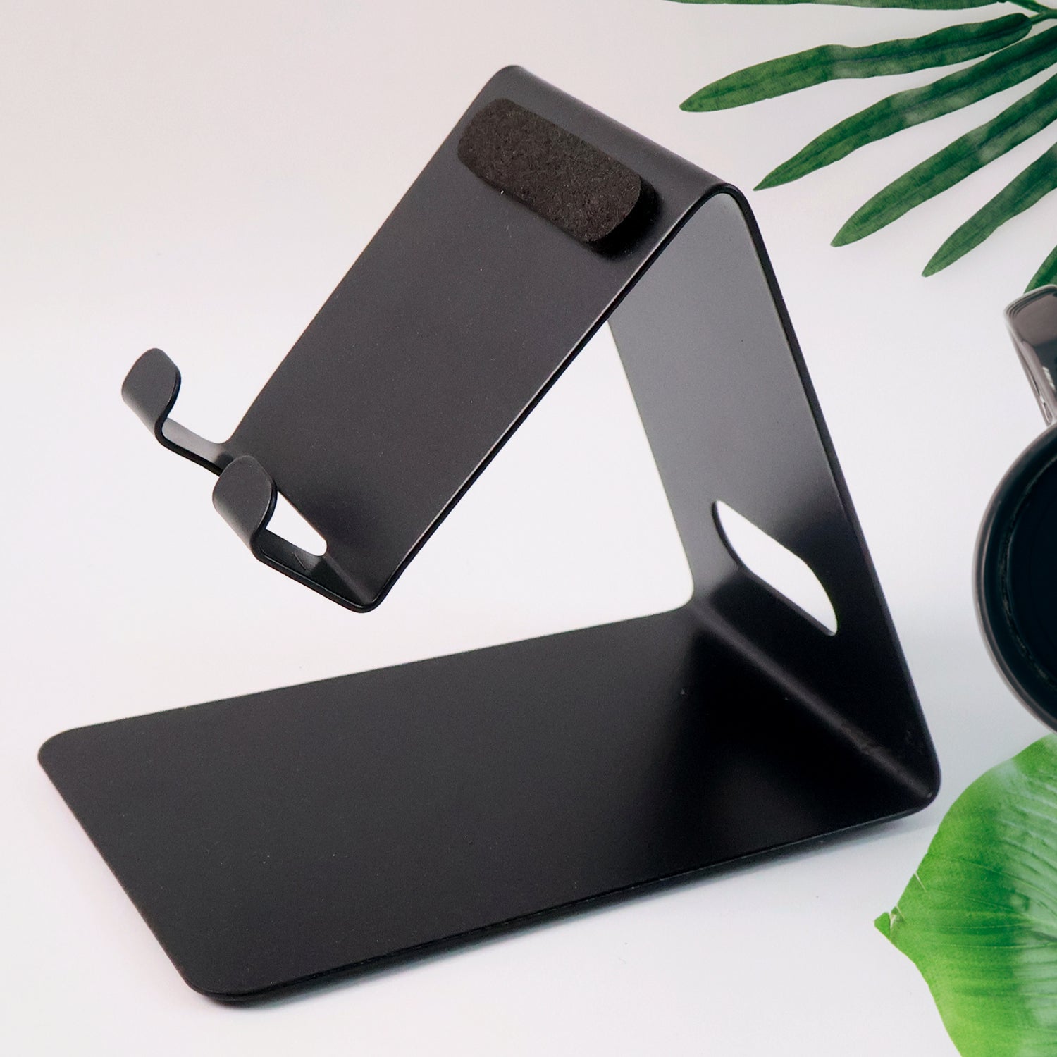 Compact metal mobile stand angled to hold a smartphone securely