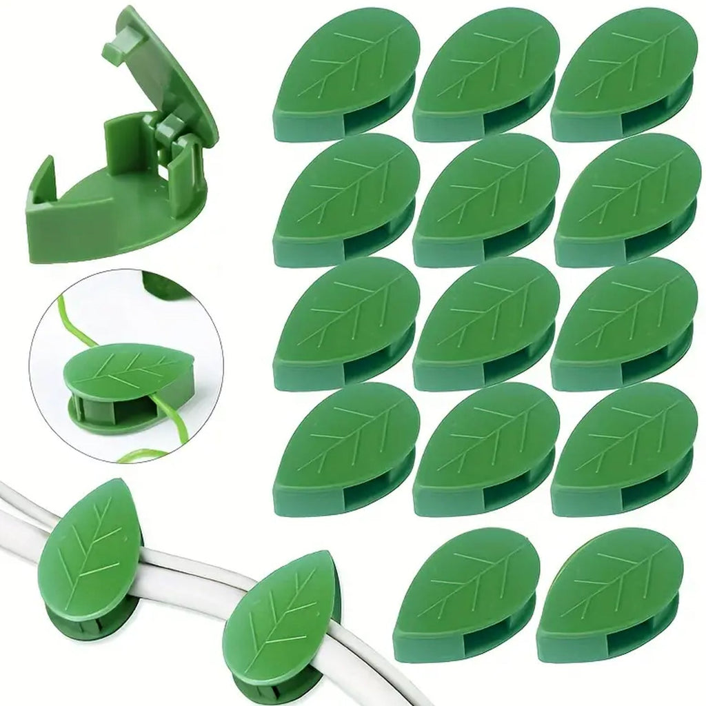 Detail view of a green leaf-shaped plant climbing clip with its adhesive side visible.