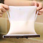 A hand holding a filled Reusable Silicone Food Storage Bag, ready for transport or storage.