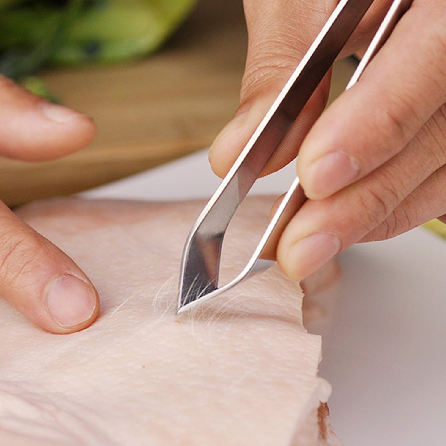 Fish bone tweezer placed on kitchen countertop showing ergonomic handle