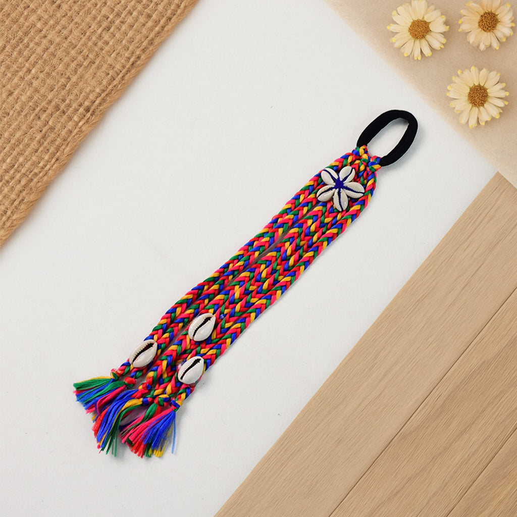 Close-up of multicolor braided hair accessory showing braided texture and shells